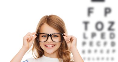 smiling cute little girl with black eyeglasses